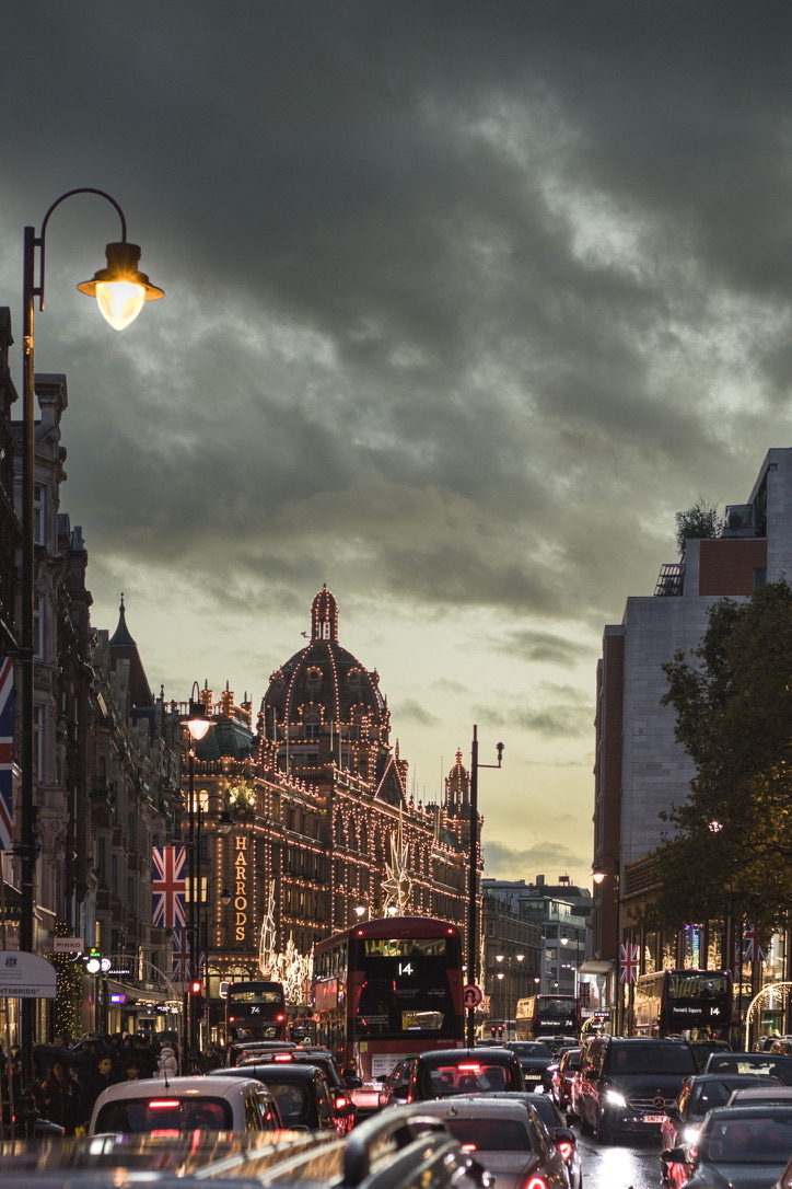 A dense compression of commuters beneath a warm commercial glow.