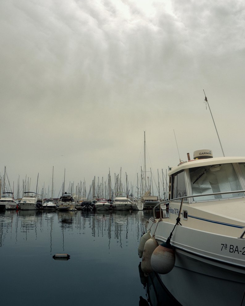 A dense compression of rigging lines beneath an overcast ceiling.
