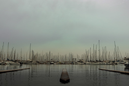 Repeating geometric lines dividing an overcast horizon canvas.
