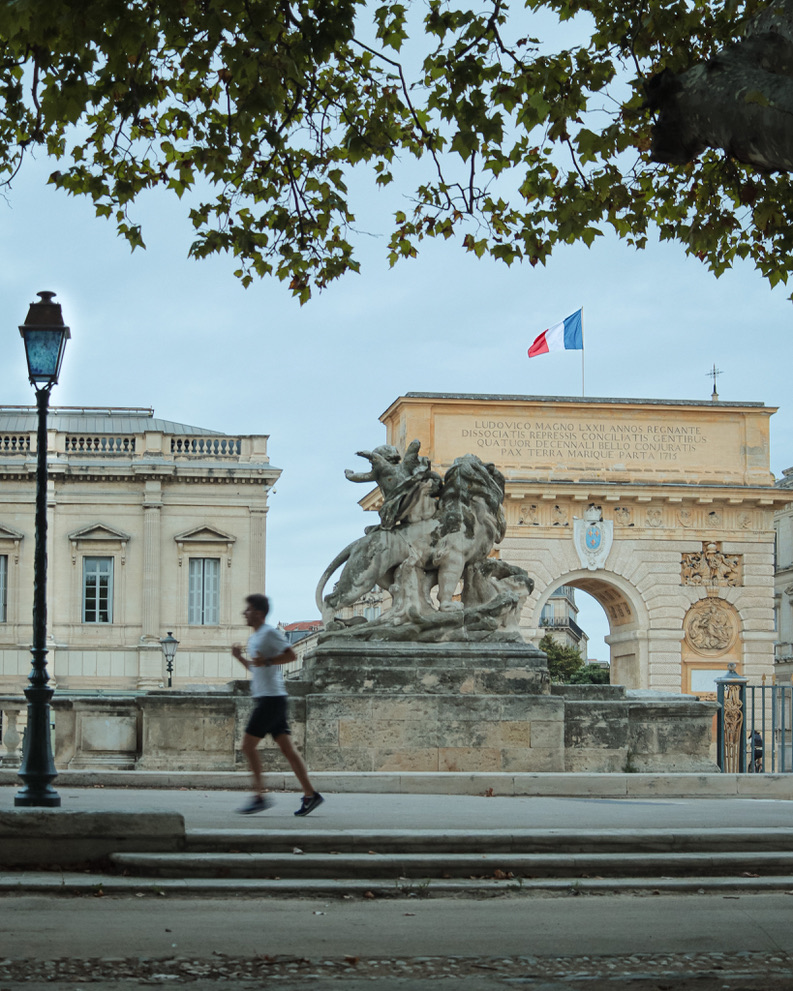 A transient human blur cutting through classical monument structures.
